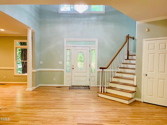 1512 Cumberland Rd, Chapel Hill, NC 27514 - entryway featuring a towering ceiling, light wood finished floors, ornamental molding, baseboards, and stairway