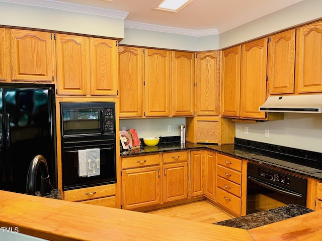1512 Cumberland Rd, Chapel Hill, NC 27514 - kitchen with black appliances, under cabinet range hood, crown molding, light wood finished floors, and dark stone countertops