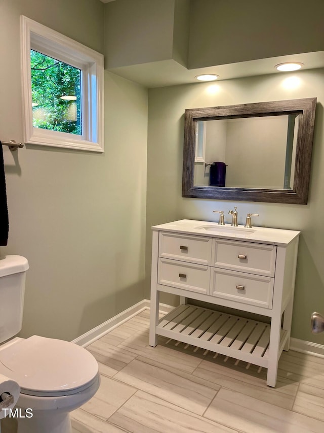 1512 Cumberland Rd, Chapel Hill, NC 27514 - half bathroom with vanity, toilet, baseboards, and wood finish floors