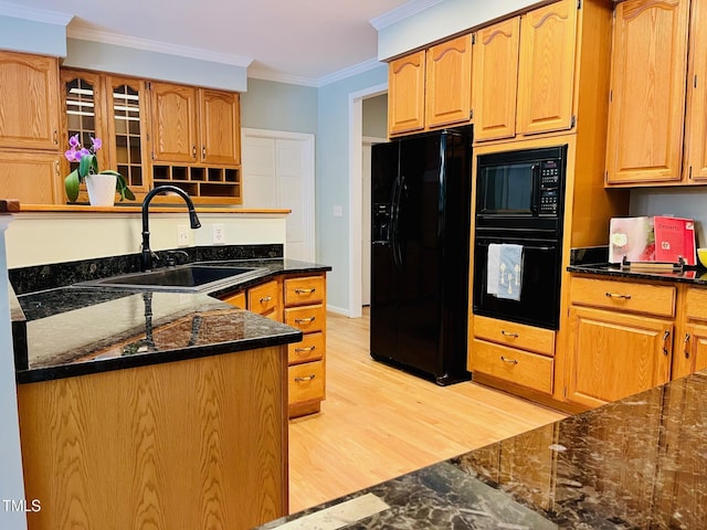 1512 Cumberland Rd, Chapel Hill, NC 27514 - kitchen with black appliances, a sink, crown molding, dark stone counters, and light wood finished floors