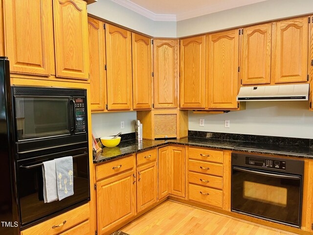 1512 Cumberland Rd, Chapel Hill, NC 27514 - kitchen with black appliances, under cabinet range hood, light wood finished floors, dark stone countertops, and ornamental molding