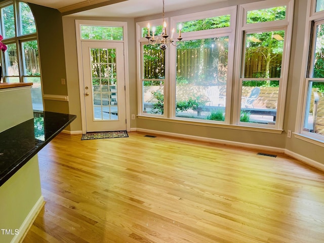 1512 Cumberland Rd, Chapel Hill, NC 27514 - doorway to outside with a chandelier, plenty of natural light, light wood-style flooring, and baseboards