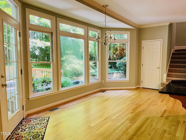1512 Cumberland Rd, Chapel Hill, NC 27514 - unfurnished dining area featuring light wood finished floors, baseboards, stairway, a chandelier, and crown molding
