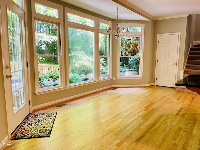 1512 Cumberland Rd, Chapel Hill, NC 27514 - unfurnished dining area with a chandelier, stairway, light wood finished floors, baseboards, and ornamental molding