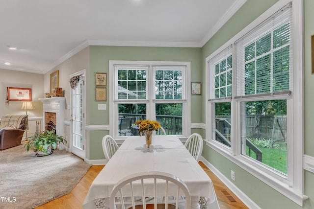 7613 Percy Ct, Raleigh, NC 27613 - dining space featuring ornamental molding, light wood finished floors, a fireplace, baseboards, and recessed lighting