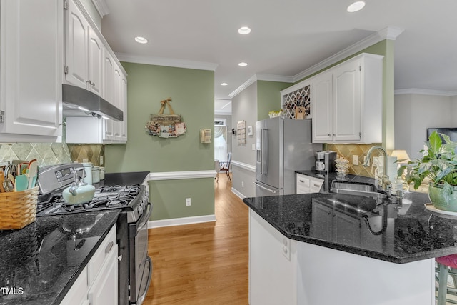7613 Percy Ct, Raleigh, NC 27613 - kitchen with stainless steel appliances, under cabinet range hood, a sink, white cabinetry, and recessed lighting