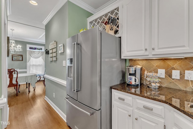 7613 Percy Ct, Raleigh, NC 27613 - kitchen featuring high end fridge, ornamental molding, backsplash, white cabinetry, and a chandelier