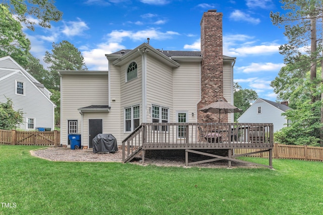 7613 Percy Ct, Raleigh, NC 27613 - back of property with a wooden deck, a gate, and a chimney