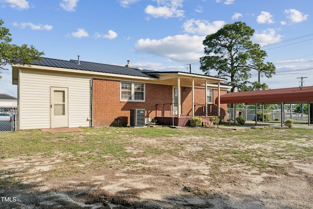 3115 Legion Rd, Hope Mills, NC 28348 - rear view of house featuring brick siding and a metal roof