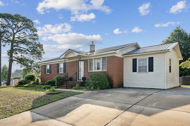 3115 Legion Rd, Hope Mills, NC 28348 - ranch-style home featuring brick siding, a metal roof, and driveway
