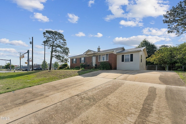 3115 Legion Rd, Hope Mills, NC 28348 - ranch-style house with driveway, brick siding, a front yard, a chimney, and a metal roof