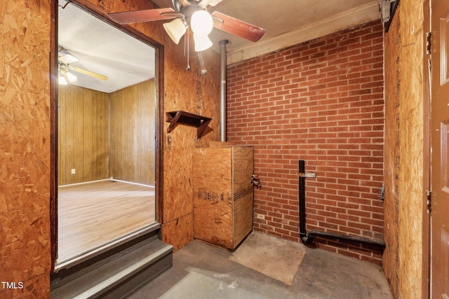 3115 Legion Rd, Hope Mills, NC 28348 - detailed view of ceiling fan, wooden walls, brick wall, and concrete floors