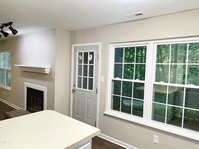 411 Gooseneck Dr Unit A1, Cary, NC 27513 - unfurnished living room featuring baseboards, a glass covered fireplace, and dark wood-type flooring