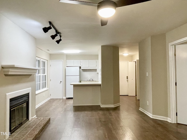 411 Gooseneck Dr Unit A1, Cary, NC 27513 - unfurnished living room with ceiling fan, dark wood-type flooring, a glass covered fireplace, and baseboards