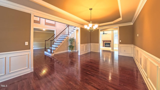 3408 Mount Pisgah Way, Cary, NC 27519 - unfurnished dining area with a decorative wall, a chandelier, dark wood-type flooring, wainscoting, and ornamental molding