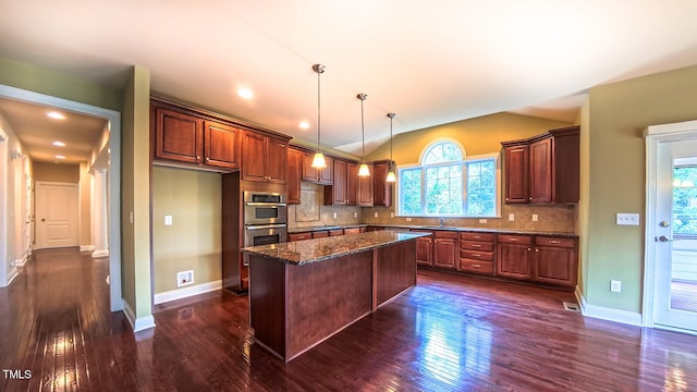 3408 Mount Pisgah Way, Cary, NC 27519 - kitchen featuring vaulted ceiling, a sink, dark wood-style floors, stainless steel double oven, and decorative backsplash