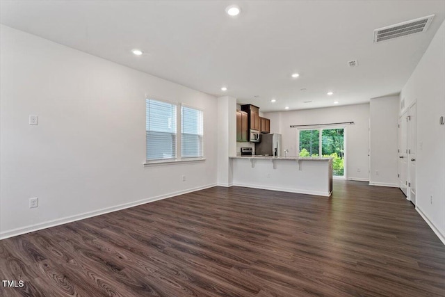 3064 Spline Cir, Raleigh, NC 27610 - unfurnished living room with dark wood-style floors, recessed lighting, and baseboards
