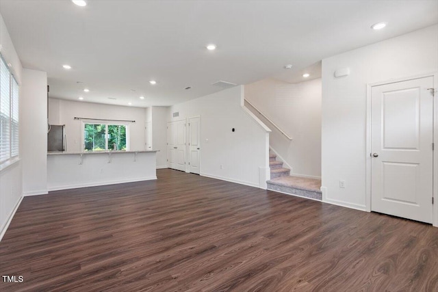3064 Spline Cir, Raleigh, NC 27610 - unfurnished living room featuring stairs, dark wood-type flooring, recessed lighting, and baseboards