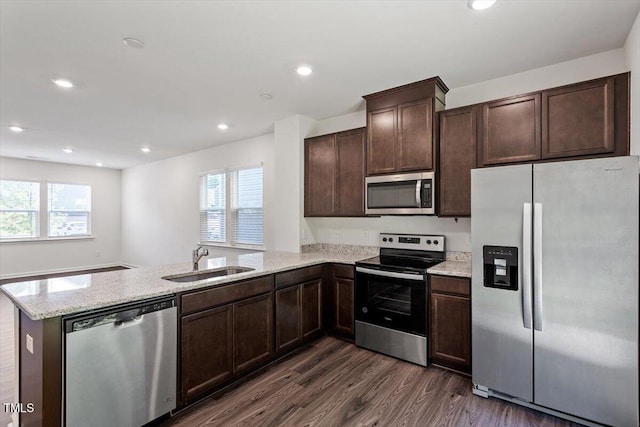 3064 Spline Cir, Raleigh, NC 27610 - kitchen featuring appliances with stainless steel finishes, a sink, a peninsula, plenty of natural light, and recessed lighting