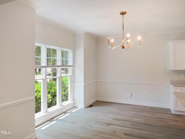 137 Wintermist Dr, Cary, NC 27513 - unfurnished dining area featuring a chandelier, wood finished floors, ornamental molding, and baseboards