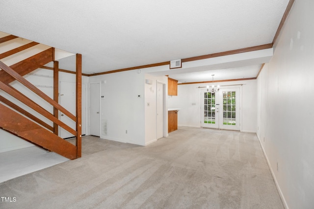 1809-1811 Quail Ridge Rd, Raleigh, NC 27609 - unfurnished living room with light carpet, stairway, baseboards, a chandelier, and ornamental molding