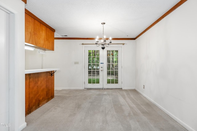 1809-1811 Quail Ridge Rd, Raleigh, NC 27609 - unfurnished dining area featuring a chandelier, light colored carpet, baseboards, crown molding, and french doors
