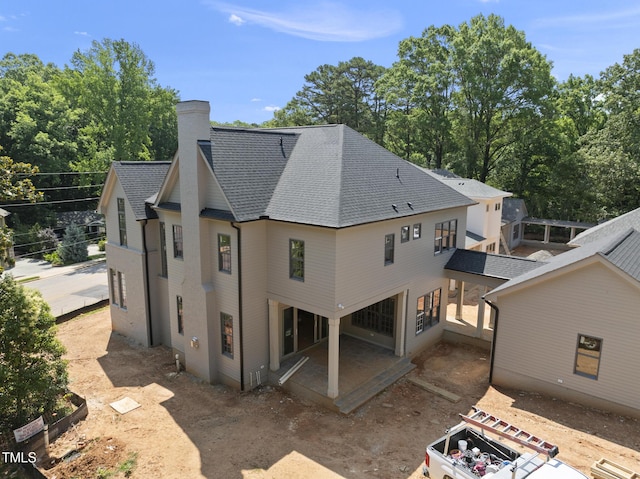 1229 Dixie Trl, Raleigh, NC 27607 - back of property with roof with shingles, a chimney, and a patio area