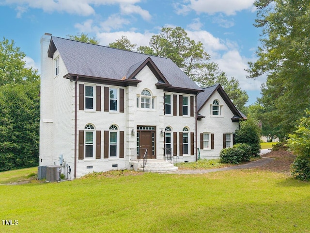 3901 Phlox Rd, Raleigh, NC 27616 - view of front of property featuring brick siding, a chimney, a front lawn, a shingled roof, and crawl space