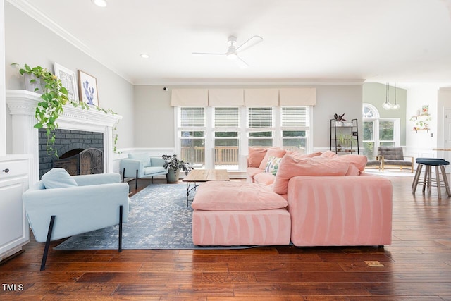 3901 Phlox Rd, Raleigh, NC 27616 - living area with crown molding, a ceiling fan, a fireplace, dark wood-style floors, and recessed lighting