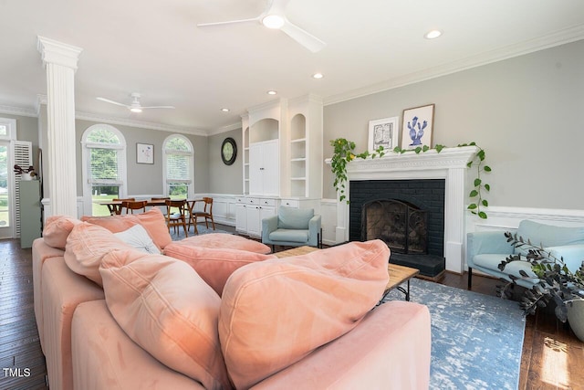 3901 Phlox Rd, Raleigh, NC 27616 - living area with a ceiling fan, wood finished floors, ornamental molding, a brick fireplace, and wainscoting
