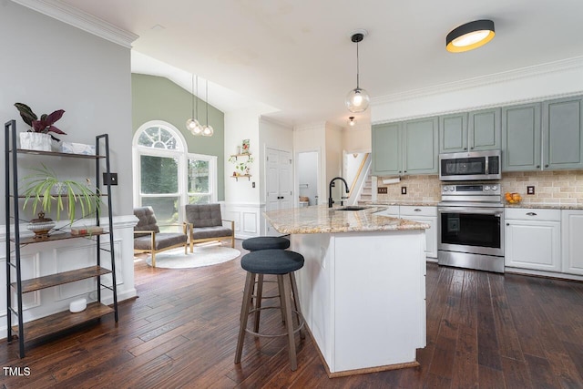 3901 Phlox Rd, Raleigh, NC 27616 - kitchen featuring appliances with stainless steel finishes, tasteful backsplash, light stone counters, hanging light fixtures, and a breakfast bar area