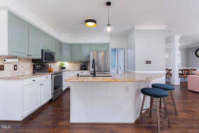 3901 Phlox Rd, Raleigh, NC 27616 - kitchen with appliances with stainless steel finishes, crown molding, backsplash, light stone counters, and a breakfast bar area