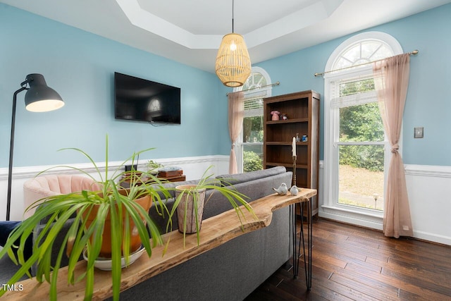 3901 Phlox Rd, Raleigh, NC 27616 - living room with a tray ceiling, dark wood finished floors, and a wainscoted wall