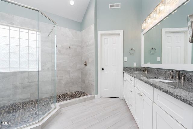 3901 Phlox Rd, Raleigh, NC 27616 - bathroom with a stall shower, double vanity, vaulted ceiling, and recessed lighting