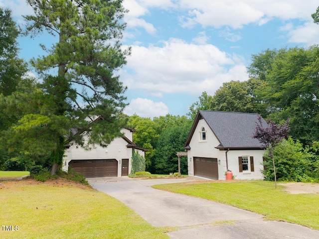 3901 Phlox Rd, Raleigh, NC 27616 - view of front of property with a front lawn, a detached garage, and driveway