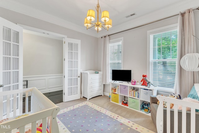 1808 Pennypacker Ln, Durham, NC 27703 - carpeted bedroom featuring a chandelier, french doors, crown molding, and a nursery area