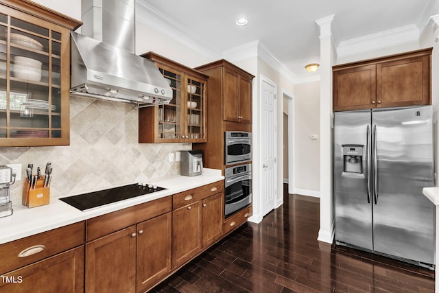 1808 Pennypacker Ln, Durham, NC 27703 - kitchen featuring appliances with stainless steel finishes, wall chimney range hood, dark wood-type flooring, baseboards, and light countertops