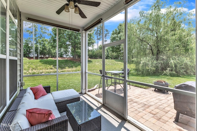 1808 Pennypacker Ln, Durham, NC 27703 - sunroom / solarium featuring a ceiling fan, an outdoor living space with a fire pit, and view of wooded area