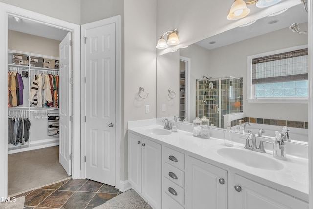 1808 Pennypacker Ln, Durham, NC 27703 - bathroom featuring double vanity, a bath, a stall shower, a walk in closet, and stone finish flooring
