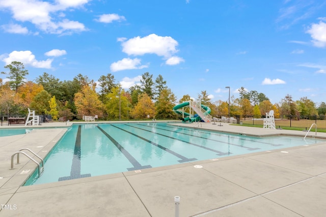 1808 Pennypacker Ln, Durham, NC 27703 - community pool with a water slide, view of wooded area, and a patio area