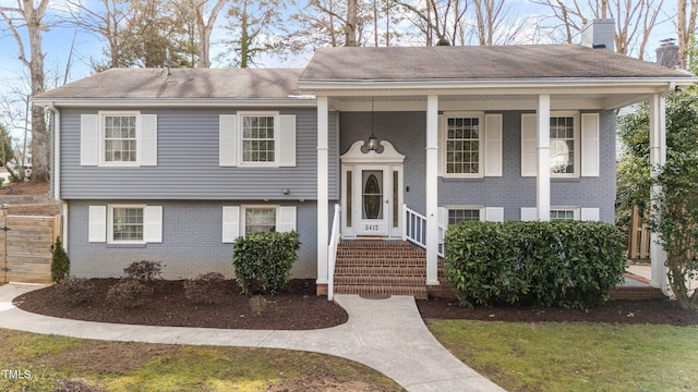 5412 Farley Dr, Raleigh, NC 27609 - raised ranch featuring brick siding, a chimney, and roof with shingles