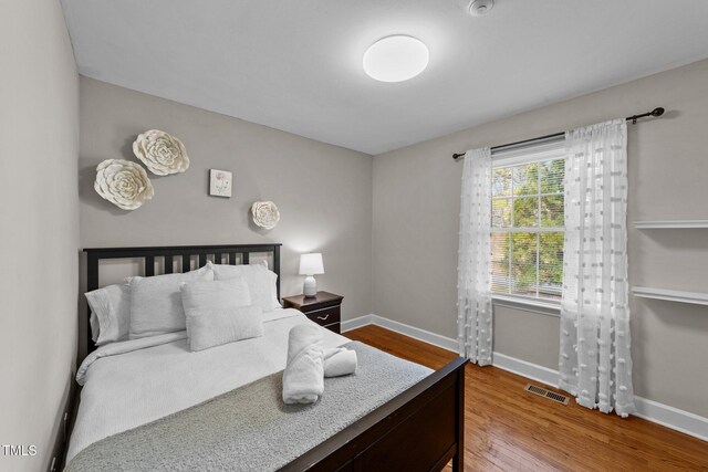 5412 Farley Dr, Raleigh, NC 27609 - bedroom featuring baseboards and wood finished floors