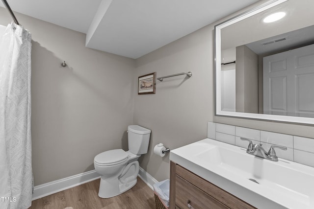 5412 Farley Dr, Raleigh, NC 27609 - full bath featuring wood finished floors, vanity, tasteful backsplash, and a shower with shower curtain