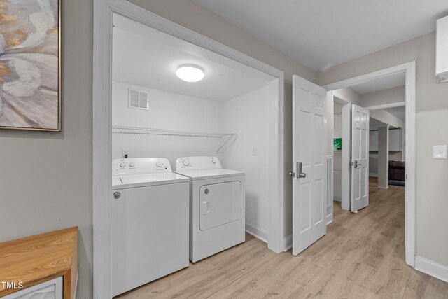 5412 Farley Dr, Raleigh, NC 27609 - washroom featuring washing machine and clothes dryer and light wood-type flooring