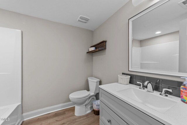 5412 Farley Dr, Raleigh, NC 27609 - bathroom featuring vanity, wood finished floors, and backsplash