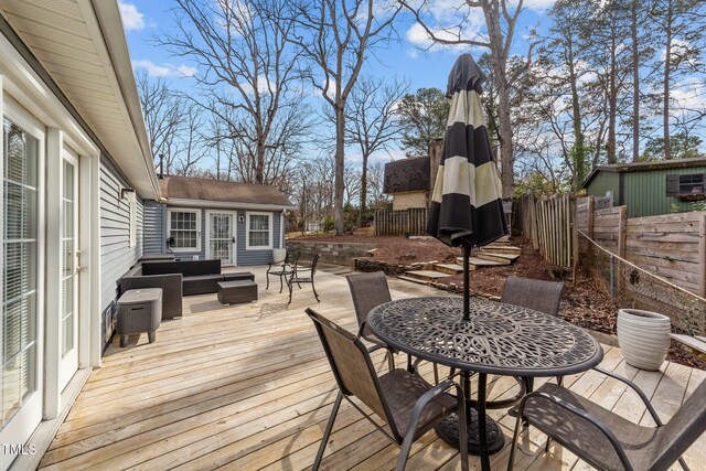 5412 Farley Dr, Raleigh, NC 27609 - wooden deck with an outdoor hangout area, a fenced backyard, and outdoor dining area