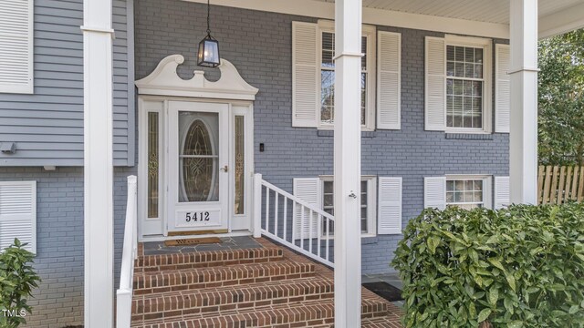 5412 Farley Dr, Raleigh, NC 27609 - view of exterior entry with brick siding and a porch