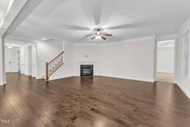 216 Pondside Dr, Apex, NC 27539 - unfurnished living room featuring a ceiling fan, stairway, dark wood finished floors, a fireplace with flush hearth, and crown molding