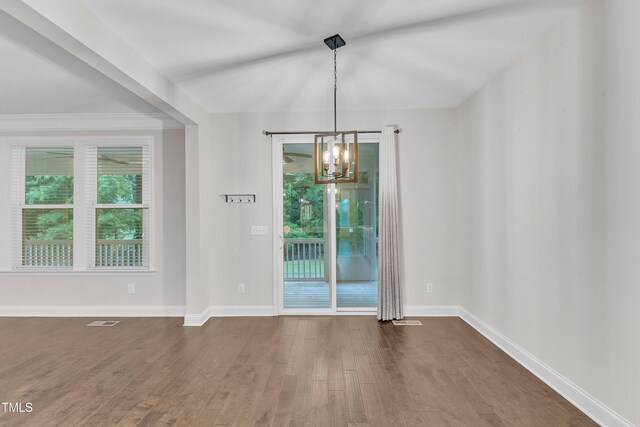 216 Pondside Dr, Apex, NC 27539 - unfurnished dining area featuring dark wood finished floors, a chandelier, and baseboards