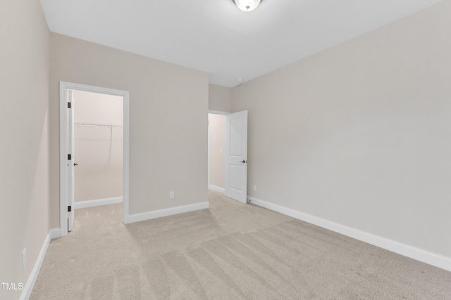 216 Pondside Dr, Apex, NC 27539 - unfurnished bedroom with light colored carpet, a spacious closet, a closet, and baseboards